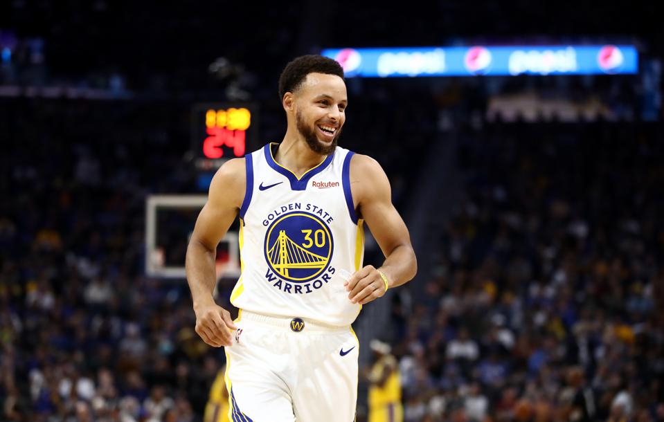 Stephen Curry smiles during a Warriors Game