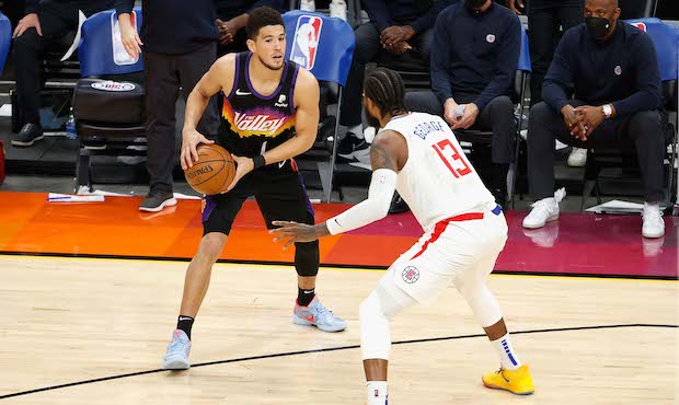 Devin Booker is guarded by Paul George in Los Angeles Clippers Vs Phoenix Suns.